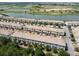 Aerial view of a beautiful townhome community with stunning water and golf course views at 1209 Payne Stewart Dr, Davenport, FL 33896
