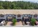 Aerial view of a charming townhome community with well-maintained landscaping, private garages and tiled roofs at 1209 Payne Stewart Dr, Davenport, FL 33896