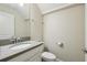 Bright half bathroom features a modern gray countertop and sleek fixtures at 1209 Payne Stewart Dr, Davenport, FL 33896