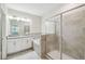 Bathroom featuring double sinks, walk-in shower, and a soaking tub at 1209 Payne Stewart Dr, Davenport, FL 33896