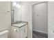 Bathroom featuring modern vanity with sleek hardware and well-lit mirror at 1209 Payne Stewart Dr, Davenport, FL 33896