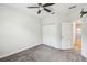 This bedroom features neutral carpet, a closet with bi-fold doors and ceiling fan at 1209 Payne Stewart Dr, Davenport, FL 33896