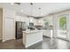Modern kitchen featuring white cabinetry, stainless appliances, and a kitchen island at 1209 Payne Stewart Dr, Davenport, FL 33896