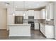 Modern kitchen features white cabinets, stainless steel appliances, and sleek gray countertops at 1209 Payne Stewart Dr, Davenport, FL 33896