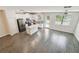 Kitchen featuring modern appliances, an island, and natural lighting from sliding glass doors at 1209 Payne Stewart Dr, Davenport, FL 33896