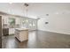 Bright open-concept living space featuring wood floors, stainless steel appliances, and a kitchen island at 1209 Payne Stewart Dr, Davenport, FL 33896