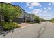 Neighborhood street view showcasing a row of charming townhomes with manicured lawns and paved driveways at 1209 Payne Stewart Dr, Davenport, FL 33896