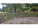 Spacious backyard with mature trees and well-maintained grass, providing a serene and private outdoor space at 6975 Sw 99Th St, Ocala, FL 34476