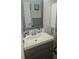 Bright bathroom featuring a modern vanity with wood drawers, a white countertop, and mosaic mirror at 6975 Sw 99Th St, Ocala, FL 34476