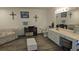 A spacious bathroom features double sinks, a large mirror, and a separate tub and toilet area at 6975 Sw 99Th St, Ocala, FL 34476
