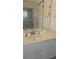A bathroom features a modern vanity with a granite countertop and a walk-in shower at 6975 Sw 99Th St, Ocala, FL 34476