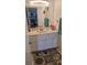 Cozy bathroom featuring a vanity with a sink, decorative rug, and ample counter space at 6975 Sw 99Th St, Ocala, FL 34476