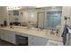 A stylish bathroom has double vanity with a spacious countertop and a walk-in shower at 6975 Sw 99Th St, Ocala, FL 34476