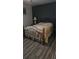A bedroom features a wrought iron bed frame and wood laminate flooring, creating a simple and functional room at 6975 Sw 99Th St, Ocala, FL 34476