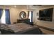 A cozy bedroom features a large bed and a dresser with a round mirror, creating an inviting space at 6975 Sw 99Th St, Ocala, FL 34476