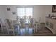 Elegant dining room with a chandelier, large window, and stylish dining set at 6975 Sw 99Th St, Ocala, FL 34476