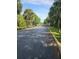 Elegant community entrance with a gated entry, palm trees, and landscaped greenery enhancing curb appeal at 6975 Sw 99Th St, Ocala, FL 34476
