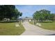 Stunning exterior view of home with a long driveway and lush landscaping at 6975 Sw 99Th St, Ocala, FL 34476