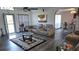 Inviting living room featuring a leather sectional, modern flooring and a large window at 6975 Sw 99Th St, Ocala, FL 34476