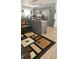The living room and kitchen are adjacent, with a bar for seating at 6975 Sw 99Th St, Ocala, FL 34476