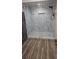 A modern walk-in shower has a sleek design with elegant marble tiling and a glass enclosure at 6975 Sw 99Th St, Ocala, FL 34476