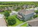 Aerial view of a home with a large backyard, featuring a covered patio and surrounded by green lawns at 12243 Sawgrass Reserve Blvd, Orlando, FL 32824