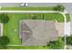 Overhead aerial view of a home showcasing a well-manicured lawn, mature trees, and a clean roof at 12243 Sawgrass Reserve Blvd, Orlando, FL 32824