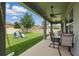 Spacious back porch featuring a ceiling fan and outdoor seating overlooking a lush, green yard with a playset at 12243 Sawgrass Reserve Blvd, Orlando, FL 32824