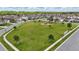 Aerial view of a community park showcasing a large grassy area and surrounding residential homes at 12243 Sawgrass Reserve Blvd, Orlando, FL 32824