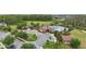 Community clubhouse and pool area featuring mature trees, a parking area and well maintained landscaping at 12243 Sawgrass Reserve Blvd, Orlando, FL 32824