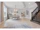 Bright dining room featuring tiled flooring, modern chandelier, and staircase at 12243 Sawgrass Reserve Blvd, Orlando, FL 32824