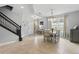 Bright dining room featuring tiled flooring, modern chandelier, and staircase at 12243 Sawgrass Reserve Blvd, Orlando, FL 32824