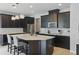 Spacious kitchen features dark cabinets, stainless appliances, and an oversized center island with seating at 12243 Sawgrass Reserve Blvd, Orlando, FL 32824