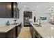 Modern kitchen featuring dark cabinetry, stainless steel appliances, and light countertops at 12243 Sawgrass Reserve Blvd, Orlando, FL 32824
