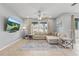 Cozy living room featuring tiled flooring, a comfortable sectional sofa and lots of light at 12243 Sawgrass Reserve Blvd, Orlando, FL 32824