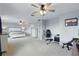 Spacious main bedroom with ceiling fans, office setup, and large windows for natural light at 12243 Sawgrass Reserve Blvd, Orlando, FL 32824
