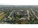 Aerial view of the neighborhood, showcasing the house within a tree-lined community at 1472 Muir Cir, Clermont, FL 34711