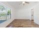 Bright bedroom featuring luxury vinyl plank flooring, a ceiling fan and outdoor views at 1472 Muir Cir, Clermont, FL 34711