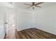 Bright bedroom featuring wood floors, ceiling fan, closet, and white walls at 1472 Muir Cir, Clermont, FL 34711