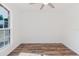 Bright bedroom featuring hardwood floors and a large window with outdoor views at 1472 Muir Cir, Clermont, FL 34711