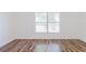 Bright bedroom with hardwood floors and a large window at 1472 Muir Cir, Clermont, FL 34711
