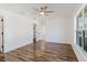 Bright bedroom with luxury vinyl plank flooring and an attached closet and doorway at 1472 Muir Cir, Clermont, FL 34711