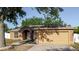 Charming single-story home with a two-car garage and manicured landscaping at 1472 Muir Cir, Clermont, FL 34711