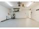 Well-lit garage featuring a water heater, sink, and ample storage space at 1472 Muir Cir, Clermont, FL 34711