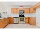 Kitchen featuring stainless steel appliances, ample counter space and natural wood cabinets at 1472 Muir Cir, Clermont, FL 34711