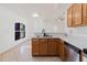 Open kitchen with stainless steel appliances and wooden cabinets at 1472 Muir Cir, Clermont, FL 34711