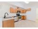 Well-equipped kitchen featuring stainless steel appliances and oak cabinets at 1472 Muir Cir, Clermont, FL 34711