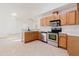 Bright kitchen offering stainless steel appliances, wood cabinets, and an open layout at 1472 Muir Cir, Clermont, FL 34711
