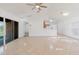 Open living room with tile flooring, ceiling fan and sliding glass doors at 1472 Muir Cir, Clermont, FL 34711