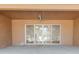 Covered patio features a ceiling fan and sliding glass doors to the interior at 1472 Muir Cir, Clermont, FL 34711
